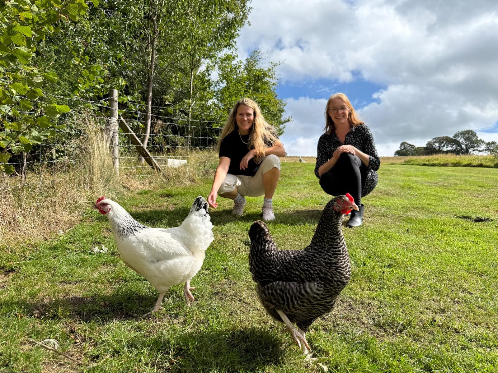Sally and Sam outdoors with Pepper the cockerel